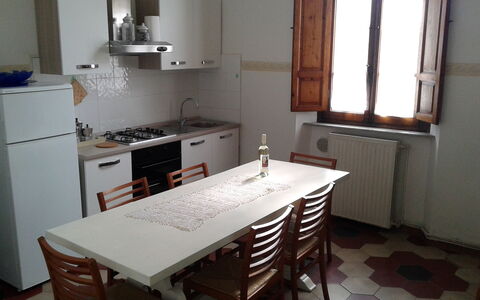 Full kitchen on the first floor, equipped with everything you need.
It includes a solid wood table with 8 chairs, a small sofa and a pantry. There is also a color TV